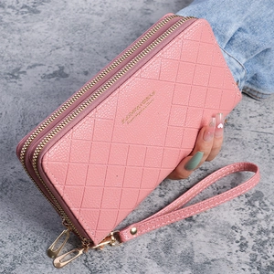 Detailed shot of pink PU leather wallet with quilted pattern and dual zippers