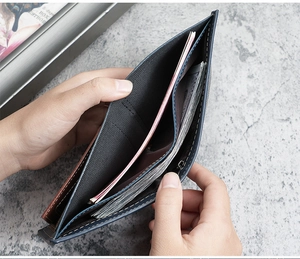 Close-up of business wallet showing multi-layer accordion slots and fine stitching details