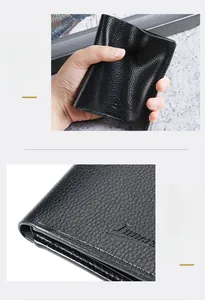Macro detail of black litchi grain leather wallet showing refined oil edge craftsmanship
