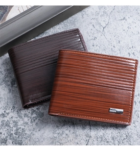 Detailed macro view of men's wallets with embossed wood grain texture and metal buckles