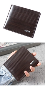 Detailed macro view of deep brown leather wallet with horizontal wood grain texture