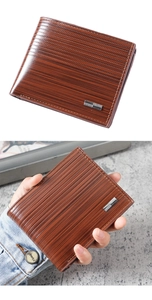 Detail view of brown wood-grain leather wallet with silver bar trim and hand-held demo