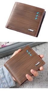 Macro view of brown short wallet for men featuring horizontal striped texture and metal logo