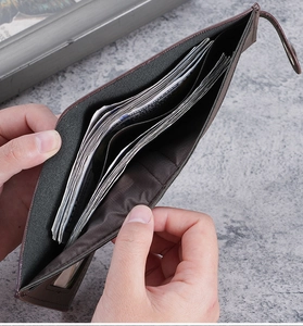 Detailed view of dark brown leather wallet interior showing cash slots and card holders