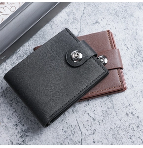 Close-up of black and brown leather bifold wallets with snap buttons and pebble texture