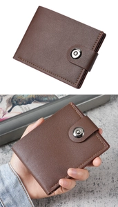 Detail view of a men's short bifold wallet in dark brown faux leather with snap closure