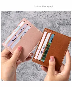 Detail of slim leather card holder with three slots in pink and brown faux leather