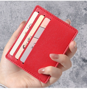 Detailed view of ultra-thin red lychee pattern card holder with three vertical slots