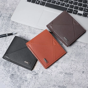 Three men's slim leather wallets in black and brown on a business desk background