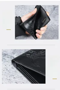 Detail of soft black leather men's wallet showing eagle pattern and durable edges