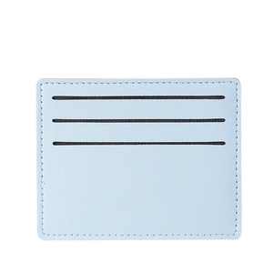 Slim light blue card holder in lychee grain leather with three slots and white background