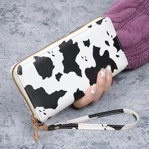 Long zip-around cow print wallet with gold zipper and detachable wristlet strap