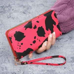 Women's long zip-around clutch wallet with red marble cow print and wristlet strap