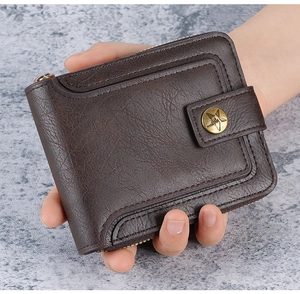 Close-up of vintage brown leather wallet with brass star emblem and zipper detail