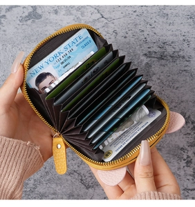 Inside view of a yellow pig-shaped accordion card holder with multiple card slots.