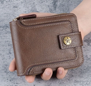 Close-up of brown leather wallet with contrast stitching and metal star emblem