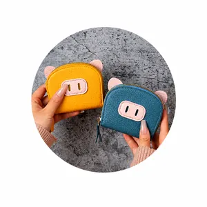 Detail of cute pig-shaped mini coin purse with litchi grain texture and metal zipper closure
