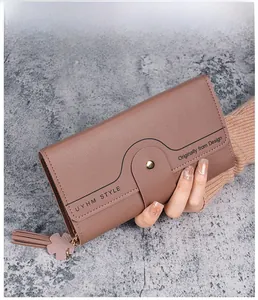 Detailed view of dust pink long wallet with litchi grain leather and tassel accent