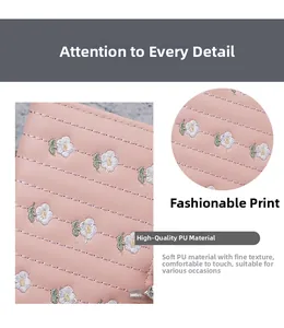 Detail of pink PU leather wallet featuring white daisy embroidery and horizontal stitching