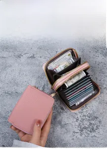Pink lychee texture leather card holder with dual zippers and multi-slot interior structure