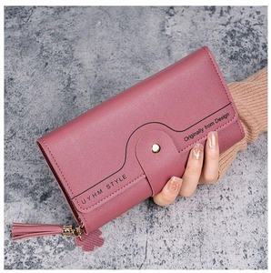 Detail of rose pink long wallet featuring wave stitching and delicate tassel pendant