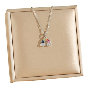 Rainbow cubic zirconia necklace with diamond clouds on a gold jewelry box display
