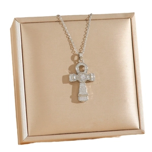 Silver Ankh key pendant necklace with cubic zirconia on a champagne jewelry box