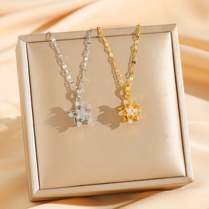 Minimalist 360-degree rotating star pendant necklace in gold and silver steel finish