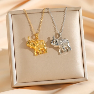 Elegant gold and silver elephant pendant necklaces with crystals on champagne silk display