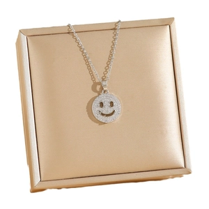 Sparkling silver smiley face pendant necklace with cubic zirconia on a gift box