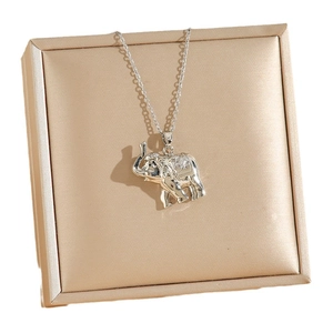 Silver elephant pendant necklace with textured detail on a jewelry gift box