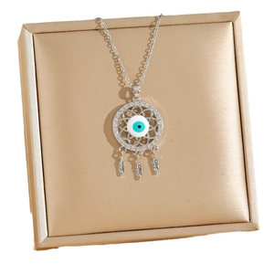 Bohemian style evil eye pendant necklace with blue zircon and feathers on jewelry box