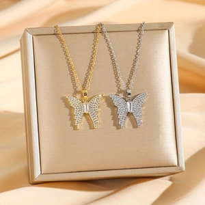 Titanium steel butterfly pendant necklace with pavé diamonds in gold and silver finishes