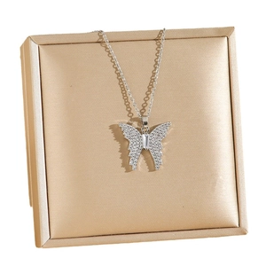 Silver butterfly pendant necklace with cubic zirconia on elegant gold satin display