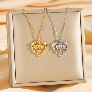 Pink zircon heart pendant necklace with bow detail in gold and silver finish