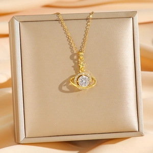 Golden planet necklace with sparkling cubic zirconia and star pendant on silk