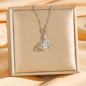 Titanium steel planet necklace featuring sparkling crystals on a golden silk background