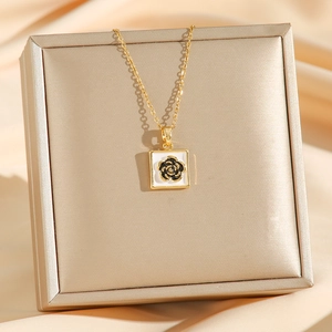 Elegant gold titanium chain necklace with white enamel camellia pendant on silk
