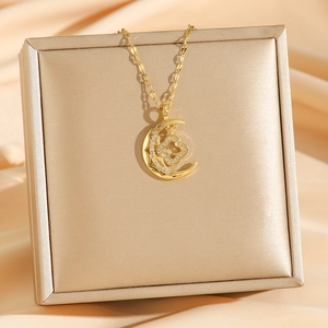 Golden moon necklace with rotating clover pendant and sparkling zircon in a jewelry box