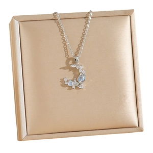 Elegant moonstone tulip necklace with crescent pendant on champagne jewelry box display