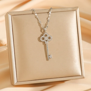 Elegant clover key necklace with 18k gold plating and shimmering cubic zirconia stones