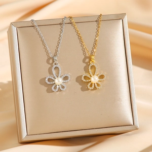 Luxurious titanium steel necklaces with pearl and pavé crystal flower pendants in gold and silver