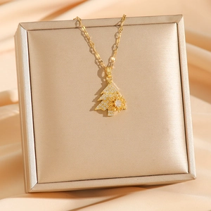 Micro-pave gold Christmas tree necklace with snowflake pendant on a jewelry gift box