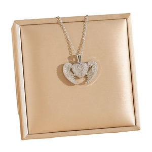 Sparkling silver angel wing heart necklace with rhinestones in a luxury gold jewelry box