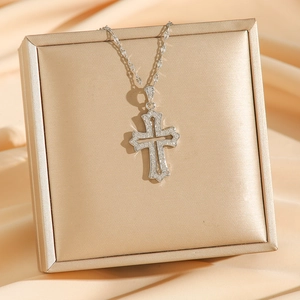 Baroque silver cross pendant necklace with zircon stones on champagne gold jewelry box