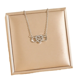 Silver infinity heart pendant necklace with micro-set zircons on elegant display
