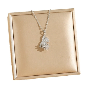 Mechanical bear pendant necklace with full zircon setting on a gold satin jewelry pad