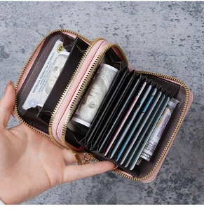 Pink PU leather card holder detail showing eleven accordion slots and dual zipper pockets