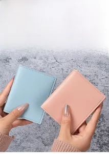 Close-up of light blue and pink slim PU leather card holders with neat stitching detail