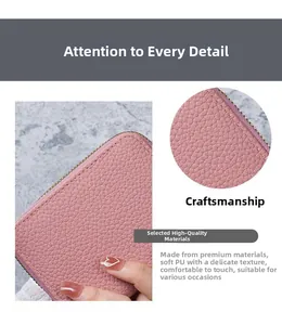 Close-up of soft pink lychee pattern PU leather and golden zipper detail on the wallet